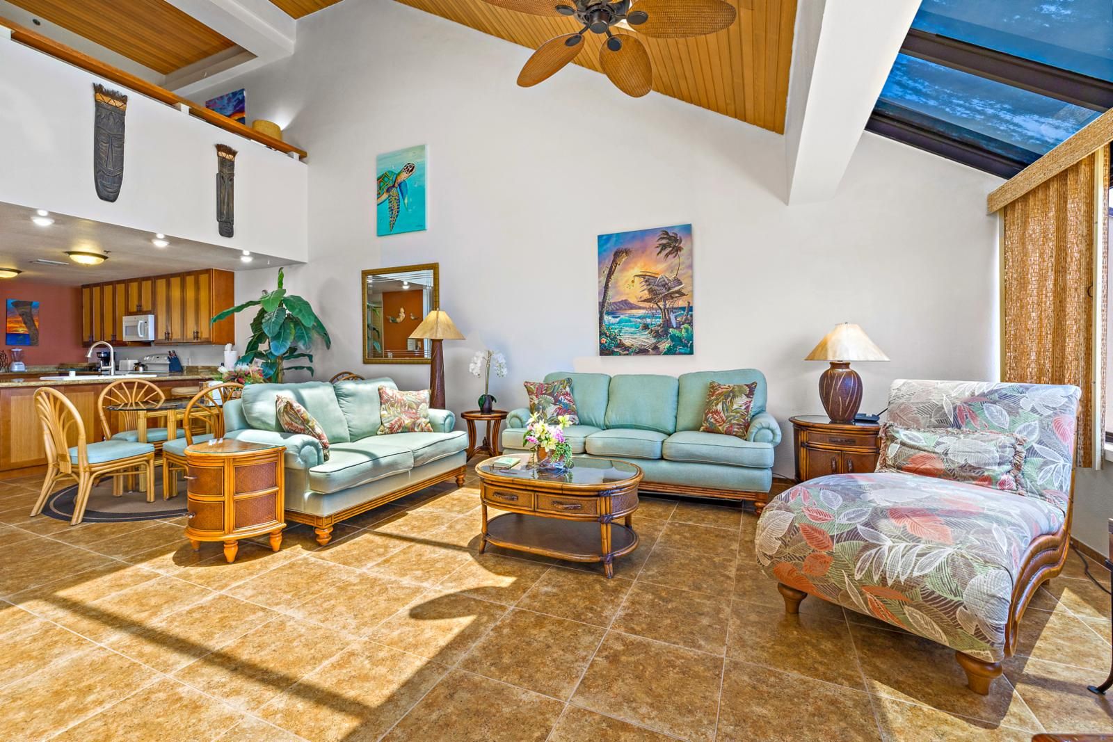 A spacious living area with a high ceiling, a dining area, and a kitchen.