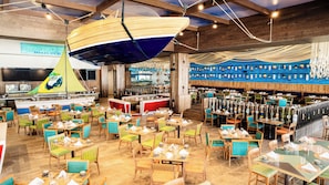 A restaurant with multiple dining areas, a bar, and a kitchen.