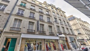 A multi-story building with a ground-floor boutique store and a visible restaurant. - A paradise for food lovers- An essence of French gastronomy in Montrogueil (Paris)