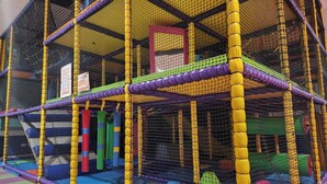 A multi-level indoor play area with netted walls and padded flooring. - Apartment With Access to Pool, Spa & Soft Play (Ilfracombe)