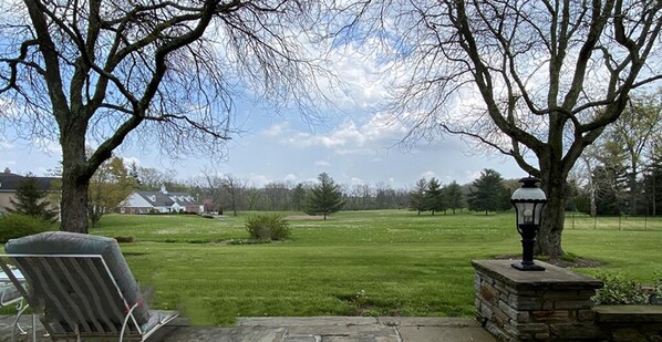 A grassy lawn with a stone lamp post and a chair. - Exquisite, first floor stone ranch Gettysburg large kitchen/living area - quiet (Gettysburg)
