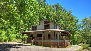 A two-story house with a porch and a covered front porch area.