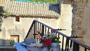A table set outdoors with a view of a mountain and traditional architecture.