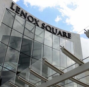 LENOX SQUARE features a sleek glass facade reflecting the surrounding environment.