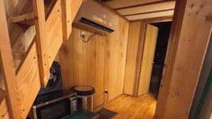 A compact wooden kitchen with a microwave, a small stove, and a ventilation system. - The Oak Oasis - Gorgeous views and a hot tub (Ansted)