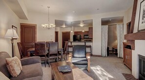 Relax in a spacious living room with a sofa, coffee table, dining area, and kitchenette.