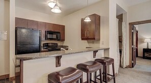 Enjoy cooking in this well-equipped kitchen with a central island and stainless steel appliances.