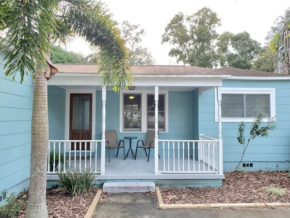 Enjoy a peaceful retreat in this charming single-story home surrounded by lush vegetation and a porch.