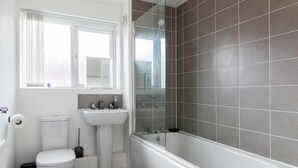 A bathroom with a toilet, sink, and bathtub. - Levon House, Coventry - 2 Bedroom Apartment (Coventry)