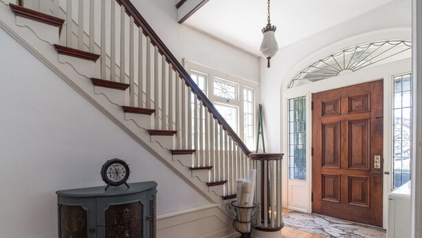 A staircase with white railings and wooden steps leading to a door with glass panels. - The Captain's Quarters (Dunkirk)