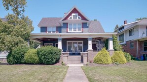 A two-story house with a front porch, a chimney, and a mailbox. - The Captain's Quarters (Dunkirk)