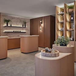 Welcome to our lobby, featuring a sleek reception desk, elegant storage cabinets, and a beautiful marble wall.
