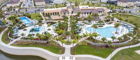 Experience the beauty of the outdoor resort-style pool area, surrounded by lush landscaping and inviting lounge chairs. The shimmering water reflects the sun, creating an oasis feel that enhances your relaxation and enjoyment.