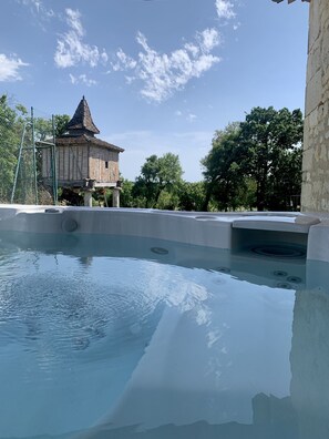A swimming pool with a stone building in the background.