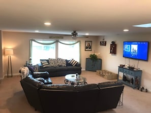 Relax in this stylish living room with a sofa, smaller couch, and TV for entertainment.