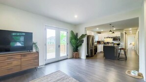 A modern kitchen with a central island, a built-in oven, and a refrigerator. - Huron Time - King bed! (Bayfield)