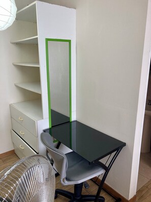 A small office space with a desk, chair, and filing cabinet.