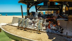 A beachside food stall with grilled fish and a sign reading "GUTIERRE Plaza". - Family house in a quiet university neighborhood (Málaga)