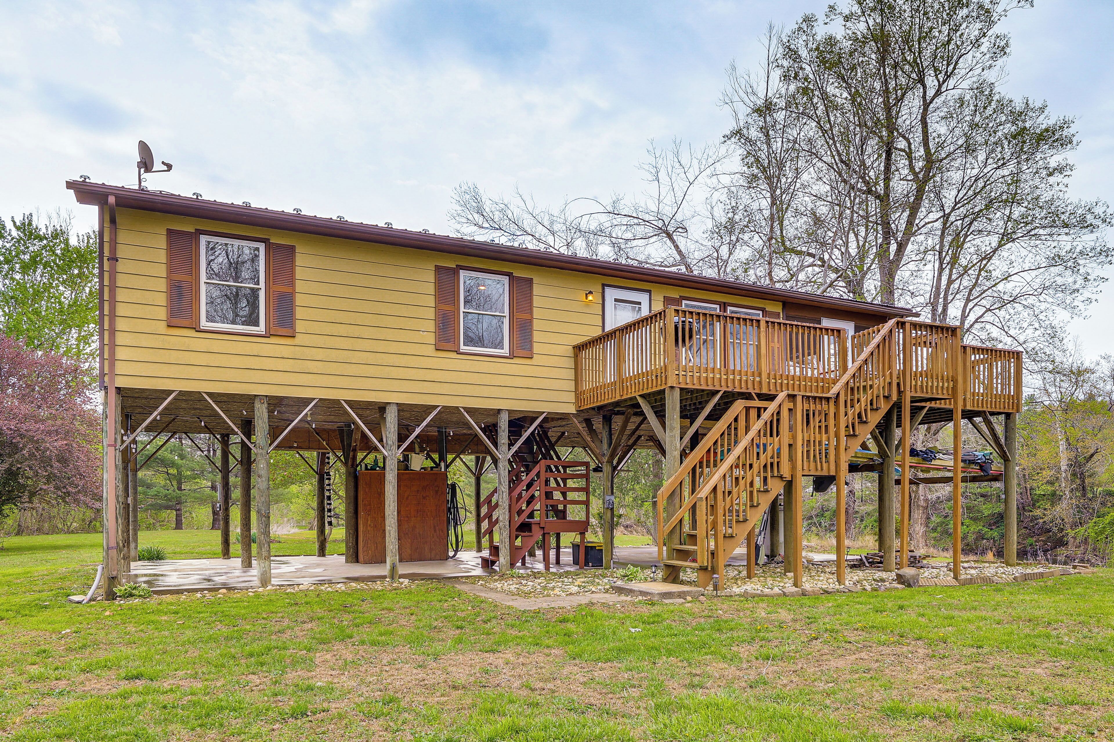 A two-story house with a deck and a covered porch.