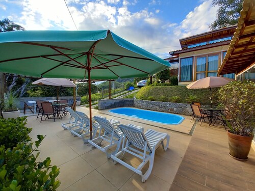 Country house with pool and outbuilding.