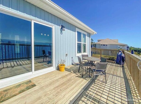 Enjoy a balcony with a table and chairs, overlooking the surrounding landscape.
