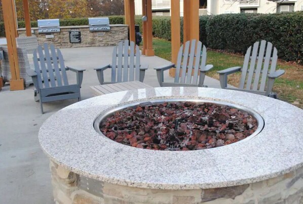 Relax and socialize around the fire pit in this inviting outdoor seating area.