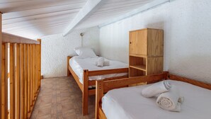 A small, cozy room with two wooden bunk beds, a wooden wardrobe, and a tiled floor. - Maison aux Oiseaux - Welkeys (Dolus-d'Oléron)