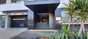 Enter a secure residential building with an entrance and stairs leading up.