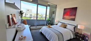 Enjoy a city view from the large window, with a comfortable bed and a relaxing seating area.