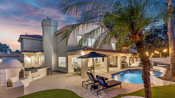 A backyard with a swimming pool, outdoor seating, and a barbecue area. - Desert Sol l Heated Pool l Hot Tub l Putting Green (Scottsdale)