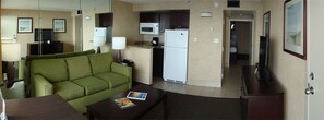 Relax in this cozy space with a kitchenette, sofa, and TV.