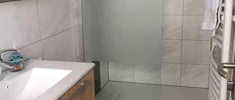 Chuveiro, secador de cabelo, toalhas de banho, papel higiênico