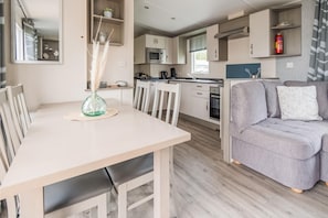 Cozy living space with a dining table, sofa, and kitchenette.