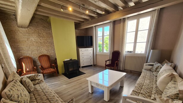 A cozy living room with a sofa, chairs, a coffee table, and a fireplace. - Townhouse in Orléans, near Loire and center (Orléans)