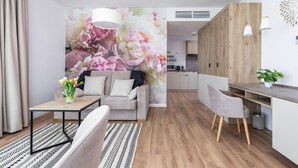 A modern living room with a sofa, coffee table, and a dining area with a bench.