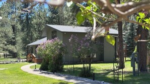 A house with a covered porch, surrounded by a well-maintained lawn and trees. - Secluded Setting On French Creek In The Southern Black Hills (Custer)