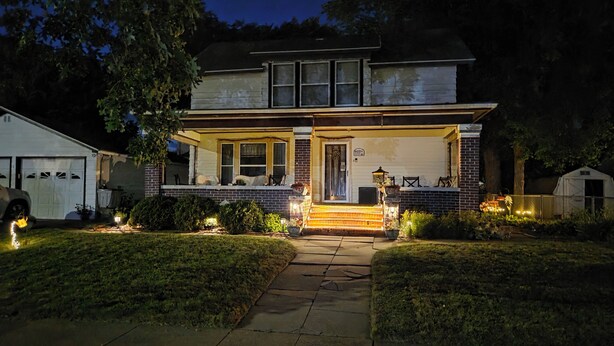 A two-story house with a front porch, a garage, and a small shed. - 1800s Home, Train-Themed Decor, Walk to Downtown & Attractions, Exclusive Perks (Boone)