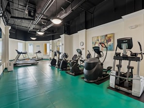A gym with treadmills, stationary bikes, and elliptical machines. - Beach Colony West #2C | Beachfront Balcony, Luxury Finishes, & Top-Notch Ameniti (Perdido Key)