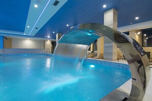 An indoor swimming pool with a modern water feature. - Hotel Agape (Zlatibor)
