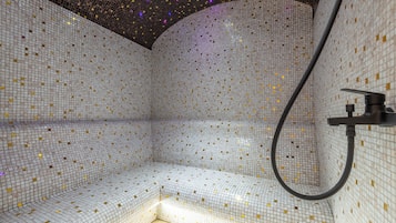 Experience a refreshing shower with a curved bench and handheld showerhead.