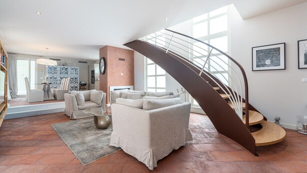 A spacious living area with a modern staircase, a dining set, and a large window providing natural light. - Elegant Villa Rafaelle with pool (Vabriga)