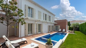 A two-story house with a swimming pool, outdoor seating, and a well-maintained lawn. - Elegant Villa Rafaelle with pool (Vabriga)