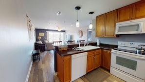 A modern kitchen with wooden cabinets, a built-in microwave, and a dishwasher. - Walk-in Condo! Enjoy The Lake Life, 3B/2B Sleeps 9, 2 Pools, Boat Slip & Beach!  (Osage Beach)