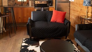 A cozy cabin interior with a kitchen, a dining area, and seating. - Serenity Ridge Cabin E: Couple's Holiday (Mill Spring)