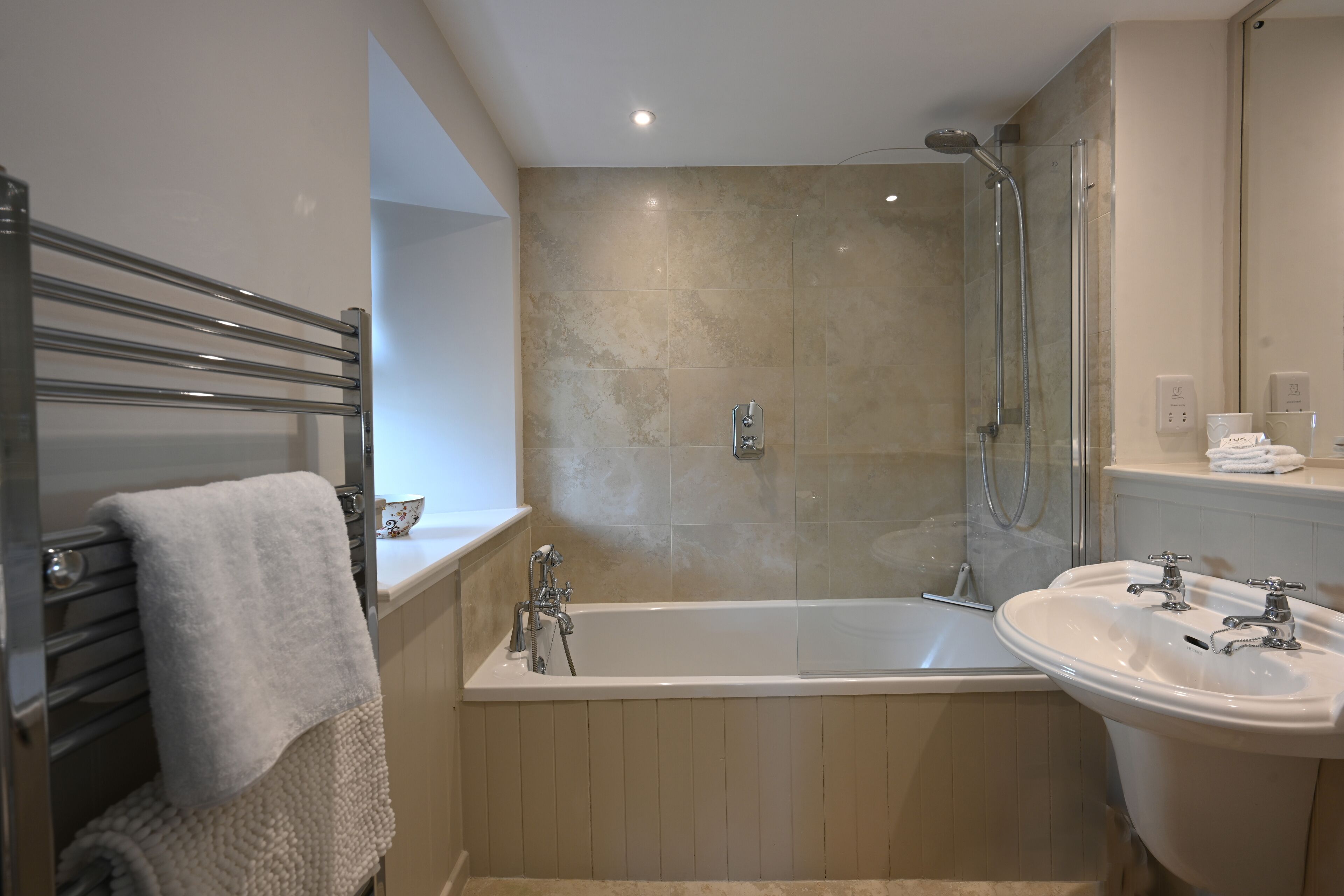 Bathtub, hair dryer, towels, soap