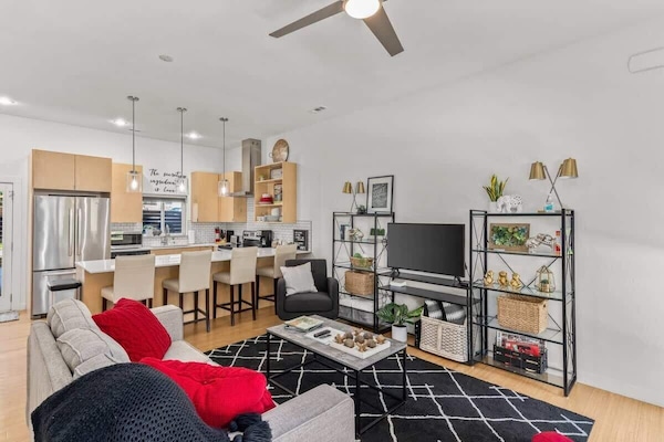 Spacious open‑concept living area with plush seating and a breakfast bar, perfect for relaxing or planning your adventures.