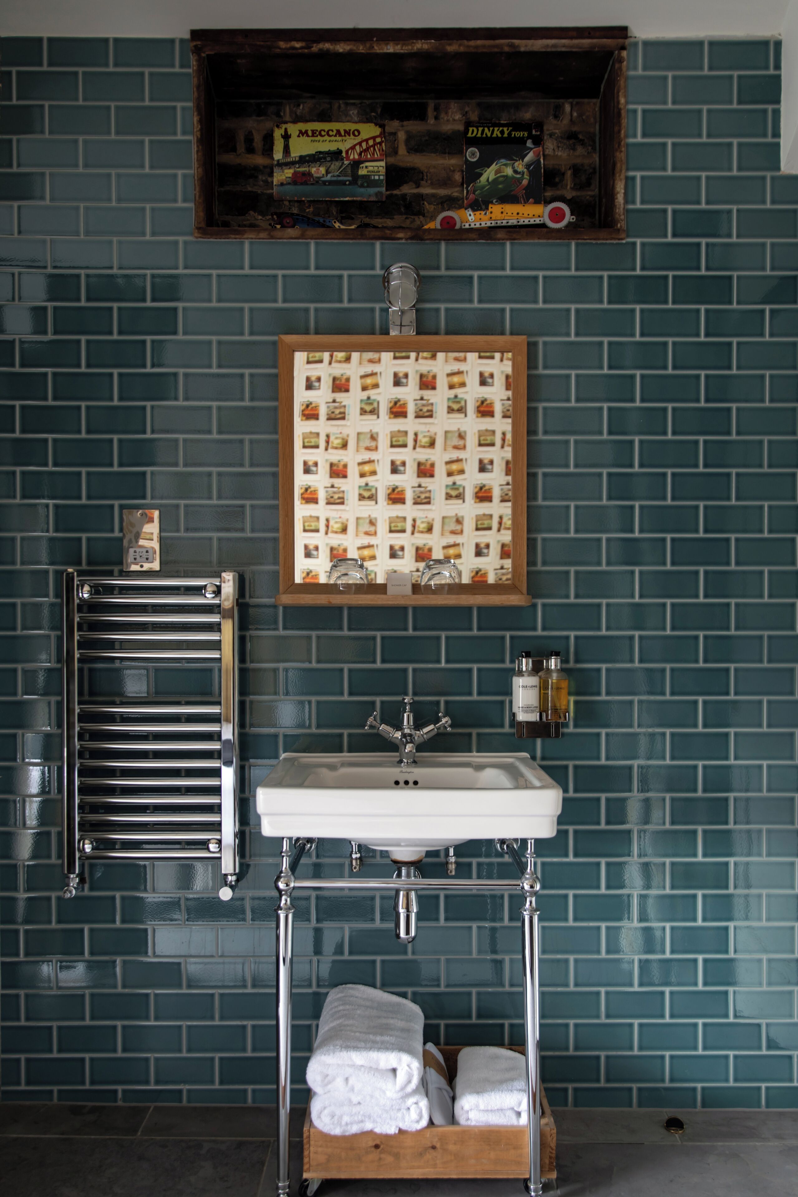 A bathroom with a sink, towel rack, and a framed menu board.
