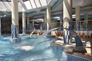 An indoor swimming pool with multiple water jets and tiled walls. - Apartment Tourist Complex & SPA Astera Bansko (Bansko)