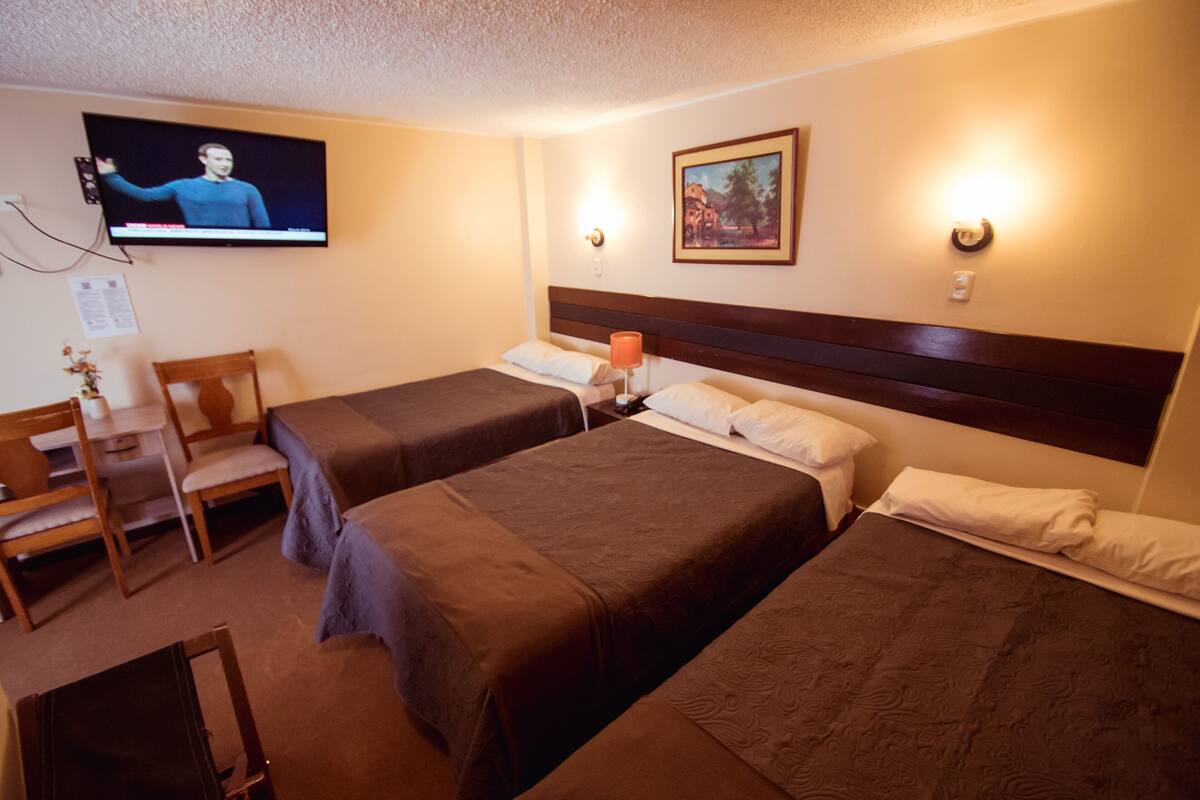 Triple Room | Desk, blackout drapes, WiFi (free), bed sheets