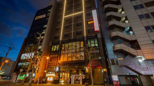 A hotel with a modern facade, large windows, and a prominent entrance. - Sapporo Classe Hotel (Sapporo)